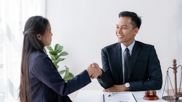 Client and Lawyer Handshake at Legal Consultation