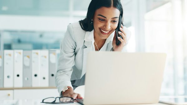 Phone call, laptop and business Indian woman in office for planning, discussion and communication.